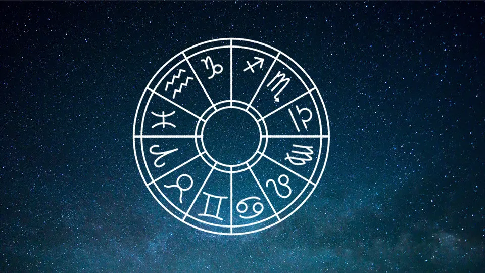 The twelve signs of the zodiac arranged in a wheel over a starlit night sky